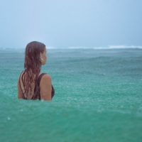 Lifestyle Photography of girl in the rain on a beach in Hawaii