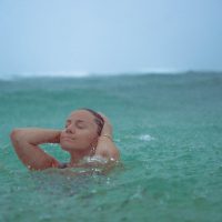 Lifestyle Photography of girl in the rain on a beach in Hawaii