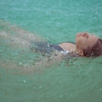 Lifestyle Photography of girl in the rain on a beach in Hawaii