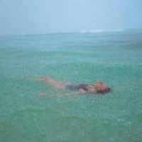 Lifestyle Photography of girl in the rain on a beach in Hawaii