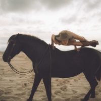 Photograph from lifestyle photography session picturing a girl on a horse on a beach in Hawaii.