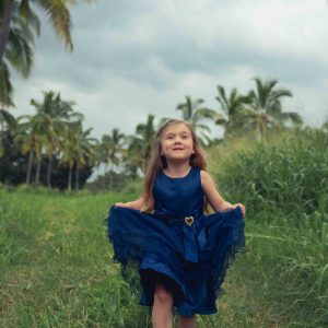 Girl running in palm tree field