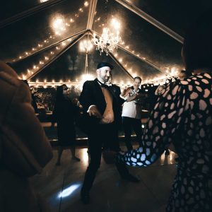 Photograph of groom dancing at wedding reception