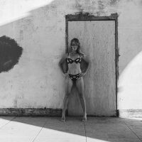 Photograph of model posing for lifestyle session. Black and white lingerie.