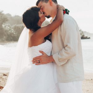 Hawaii Wedding Photographer capturing First kiss between newly weds during Kuaui Wedding