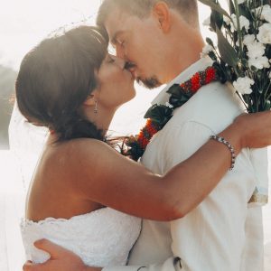 Hawaii Wedding Photographer capturing First kiss between newly weds during Kuaui Wedding