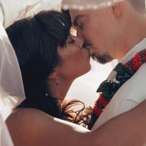 Hawaii Wedding Photographer capturing first kiss between newly weds during Kuaui Wedding