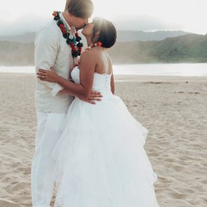 Hawaii Wedding Photographer capturing first kiss between newly weds during Kuaui Wedding